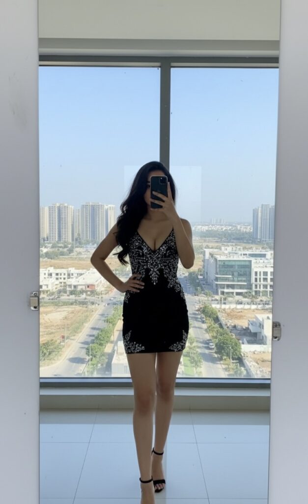 Independent girl in Mohali posing in black dress near window